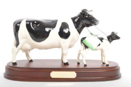 BESWICK PORCELAIN FIGURINE OF FRIESIAN COW & CALF