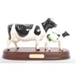 BESWICK PORCELAIN FIGURINE OF FRIESIAN COW & CALF