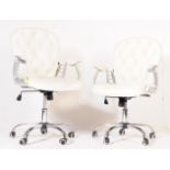 A PAIR OF RETRO VINTAGE LEATHERETTE WHITE OFFICE CHAIRS