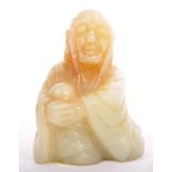 A SMALL CARVED CHINESE ORIENTAL GREEN JADE SITTING FIGURINE