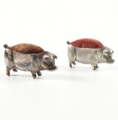 TWO WHITE METAL & METAL NOVELTY PIG PIN CUSHIONS