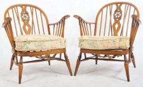 ERCOL - A PAIR OF RETRO BEECH AND ELM SPINDLE ARMCHAIRS