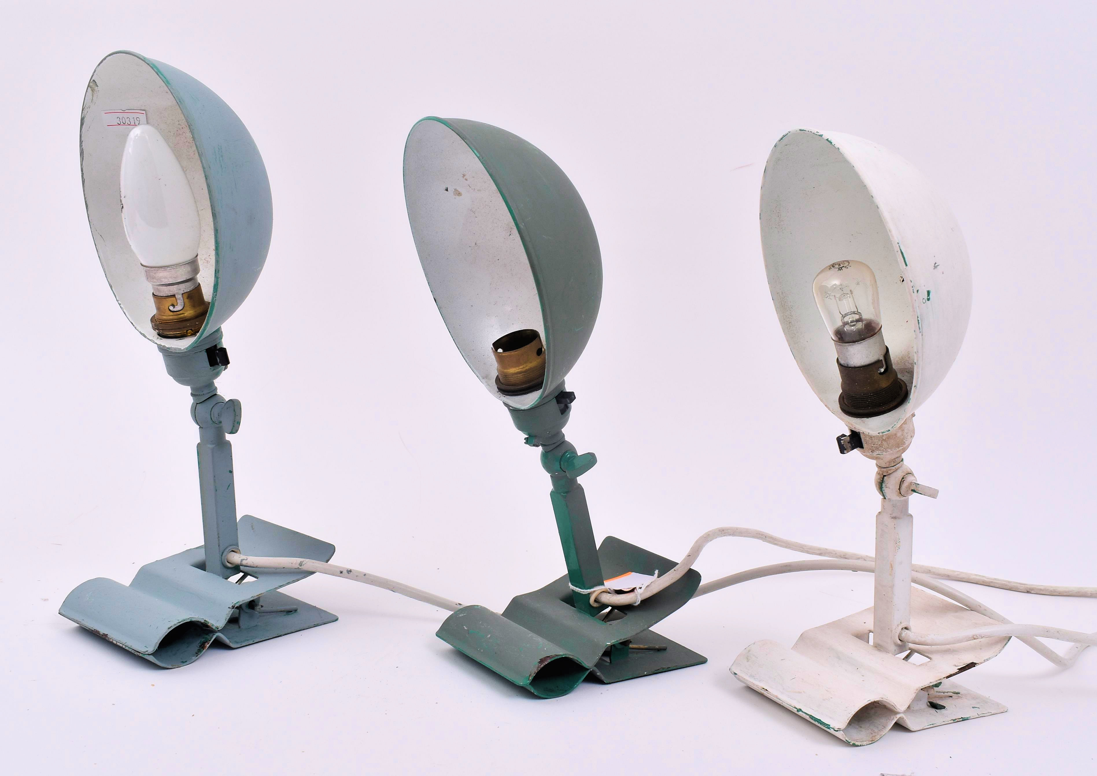 An assortment of three retro 20th century metal industrial clip-on ...