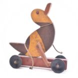 20TH CENTURY PAINTED WOODEN TOY DUCK ON WHEELS