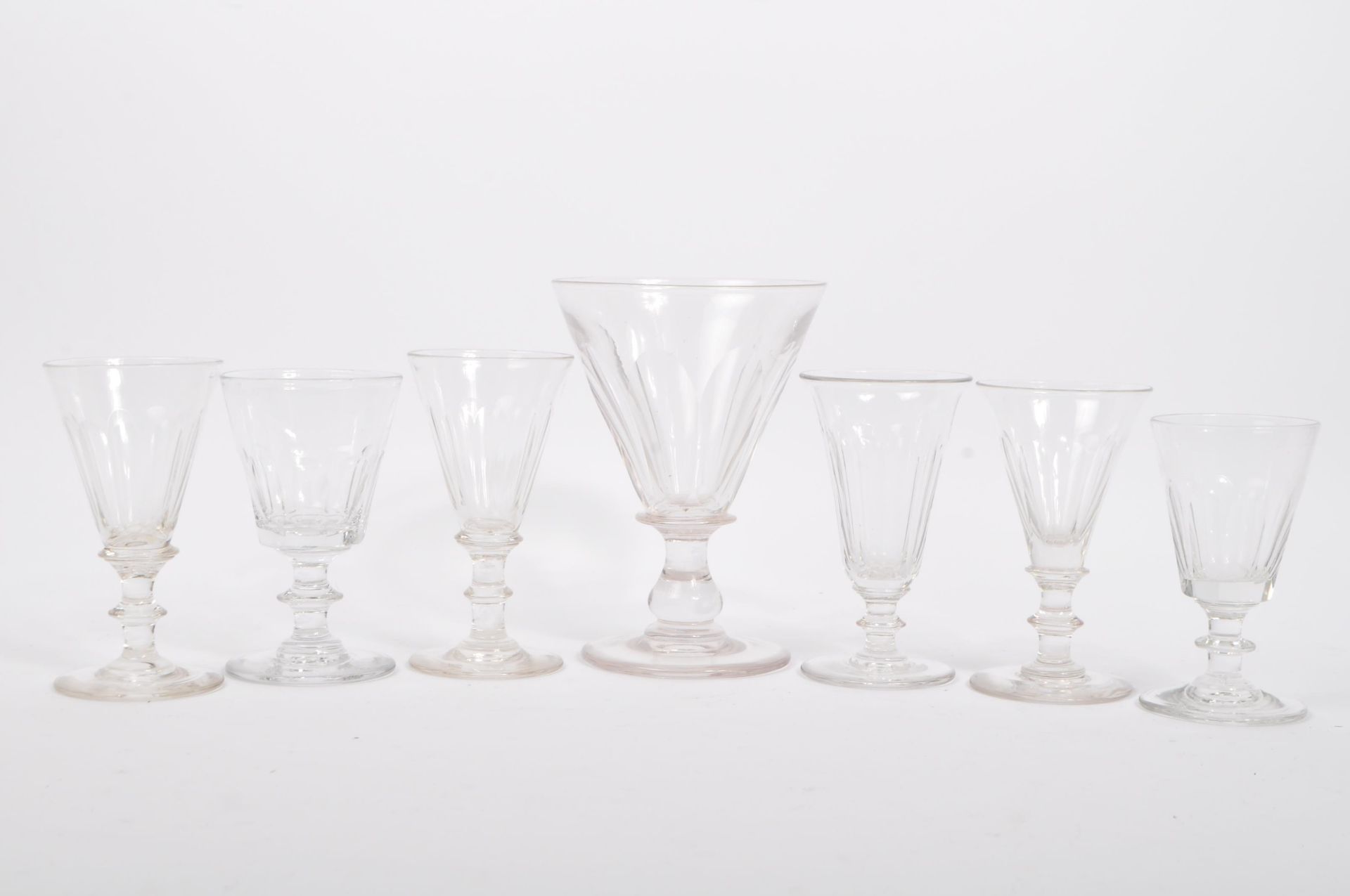 SEVEN 19TH CENTURY LATE GEORGIAN HAND BLOWN RUMMER GLASSES