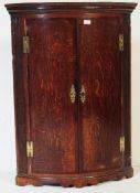 GEORGE III EARLY 19TH CENTURY BOW FRONT OAK CORNER CABINET