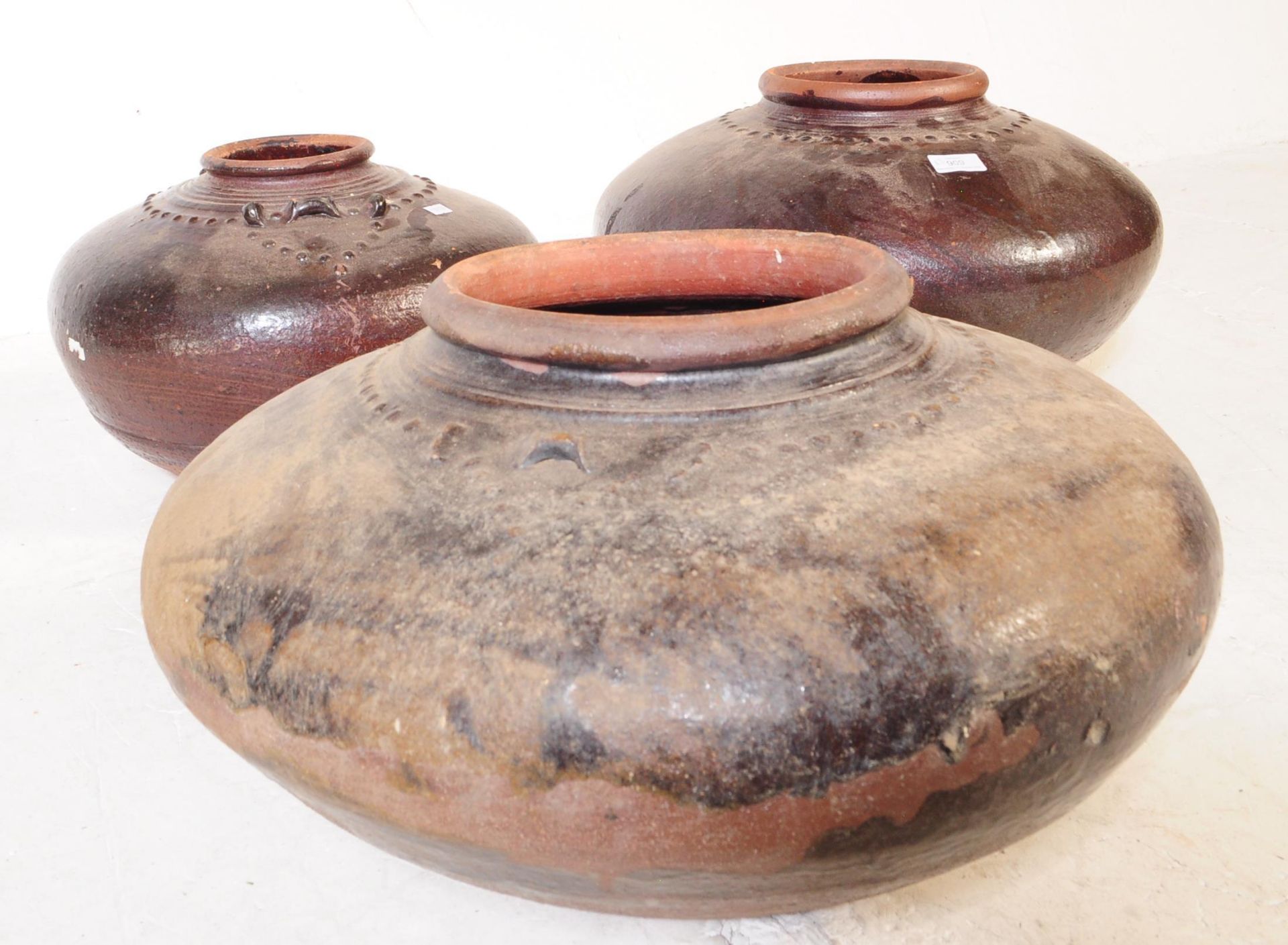 THREE EARLY 20TH CENTURY CHINESE BROWN EARTHENWARE POTS