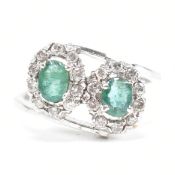 WHITE GOLD EMERALD & DIAMOND CROSSOVER RING