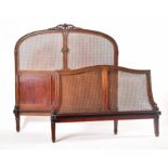 EARLY 20TH CENTURY CARVED WALNUT & WICKER DOUBLE BED FRAME
