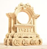 20TH CENTURY CARVED STONE ARCHITECTURAL CLOCK CASE.