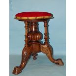 A Victorian stained walnut revolving piano stool with upholstered circular seat, 32cm diameter, 46cm