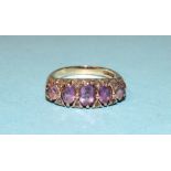 A 9ct gold ring set five graduated amethysts and diamond points, size N, 4.8g.