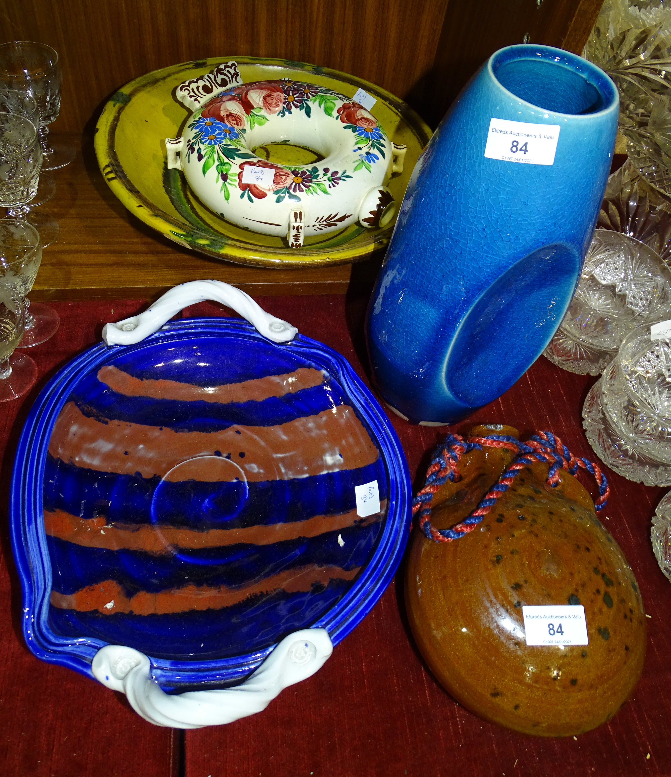 A brown-glazed slipware pilgrim flask, one other Faience-style pilgrim bottle, an Oriental studio