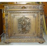 A 19th century carved oak cupboard with frieze drawer and panelled door carved with a fish and