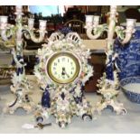 A 20th century ceramic clock set, comprising a clock with applied figures, cherubs and floral