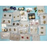 A collection of ex-shop stock Cabouchon costume earrings, 56 pairs, in packets, some on trays, a