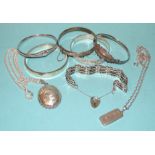 Five various silver bangles, a silver gate-link bracelet, a silver locket on chain, 130g and an