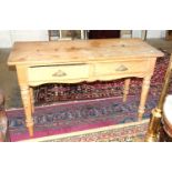 A stripped pine rectangular-top two-drawer side table on turned legs, 122 x 49cm, a pine three-
