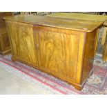 A 19th century mahogany and cross-banded bookcase base, the rectangular top above a pair of cupboard