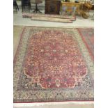 A large 20th century Oriental pattern carpet in a red/blue/green foliate design, 371 x 272cm.