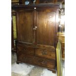 A 19th century mahogany linen press of small proportions, the dentil cornice above a pair of