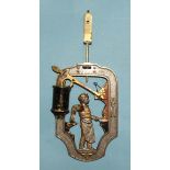An unusual metal clock pendulum automata bob, modelled with a standing blacksmith at an open fire,