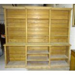 A Victorian country house pine kitchen dresser, the open top fitted with adjustable shelves, above