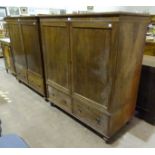A 19th century mahogany low linen press fitted with two doors above a base drawer, on short turned