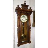 A walnut-cased Vienna-style wall clock, 125cm high, (bottom of case needs re-gluing).