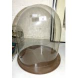 A glass dome with interior measurement 30cm wide, 38cm high, on later stand.