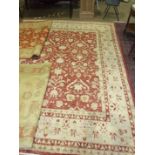 A modern wool carpet, 350 x 273cm, decorated with a foliate pattern in red/camel colours and two