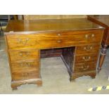 A 19th century mahogany knee-hole desk, the rectangular top above a fitted secretaire drawer and six