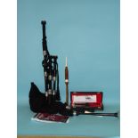 A set of modern bagpipes with assembly instructions and two practice chanters.