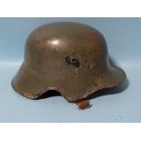 A German M18 transitional WWI/WWII helmet, with leather liner and chin strap.