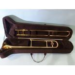 An Ammoon trombone, in case with accessories.