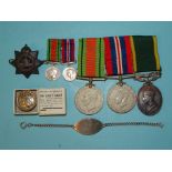 A WWII and territorial group of three medals: Defence Medal and War Medal, with miniatures and