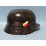 A German Luftwaffe WWII helmet, black, with leather liner and chin strap.