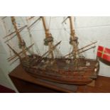 A kit-built wooden model of a three-masted Norse warship, with deck detail including gun crews,