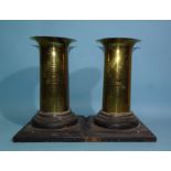 A pair of WWI trench art brass shell case vases with flared rims, etched with a wreath surrounding a