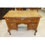 An antique walnut feather-banded lowboy, the rectangular quarter-veneered top with moulded edge,
