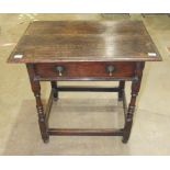 An antique oak rectangular-top side table fitted with a single frieze drawer, on turned legs