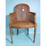 A 19th century beech-framed and caned armchair, the reeded frame carved with leaves, husks and flowe