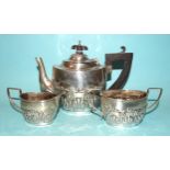 A George V three-piece silver bachelors tea service embossed with stylised scallop shell decoration,