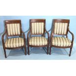 Three similar French Empire gilt metal-mounted armchairs, each with upholstered back panel and seat,