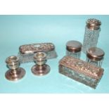 Two silver-lidded oblong cut-glass dressing table pin boxes, three silver-lidded pots and a pair