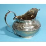 An early-Victorian silver cream jug of squat form having engraved decoration around the rim, 10cm