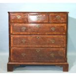 An early-18th century feather-banded walnut chest of three short and three long graduated drawers,