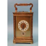 A 19th century French brass repeating carriage clock, the matted and decorative gilt dial with