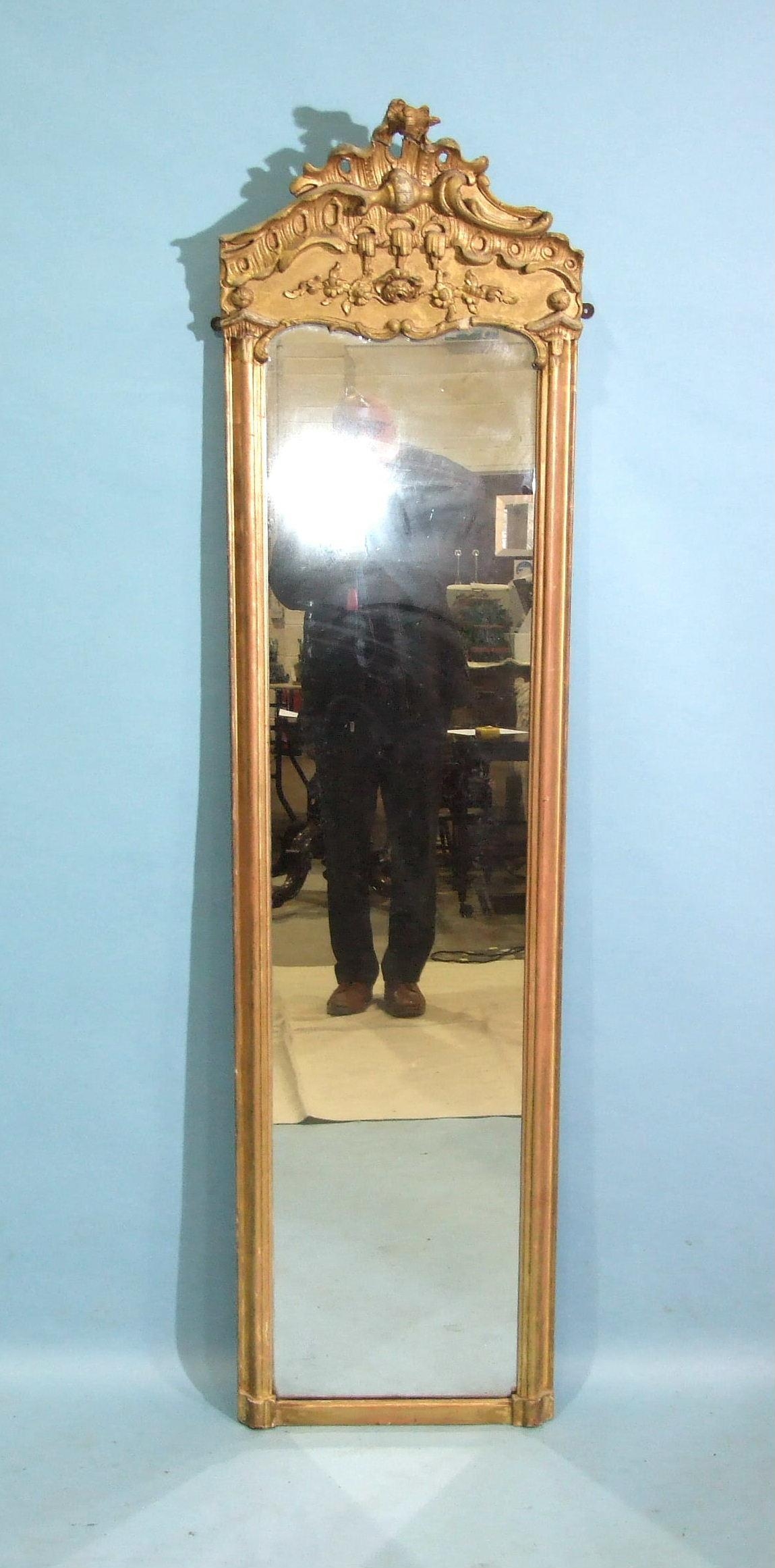 A 19th century tall gilt pier mirror, the moulded frame surmounted by Chippendale-style gesso