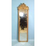 A 19th century tall gilt pier mirror, the moulded frame surmounted by Chippendale-style gesso